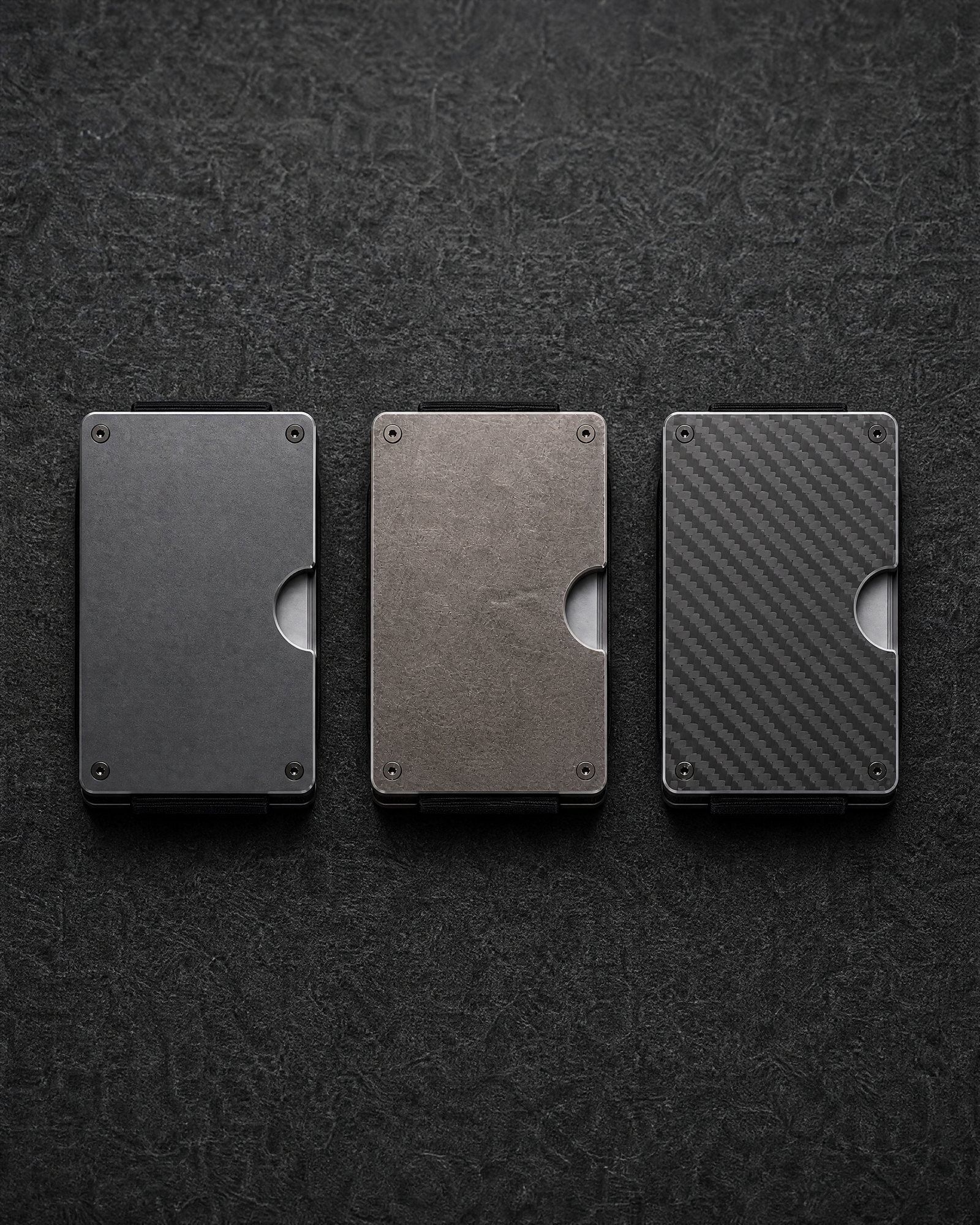 Aluminum, titanium and carbon fiber wallet plates side by side