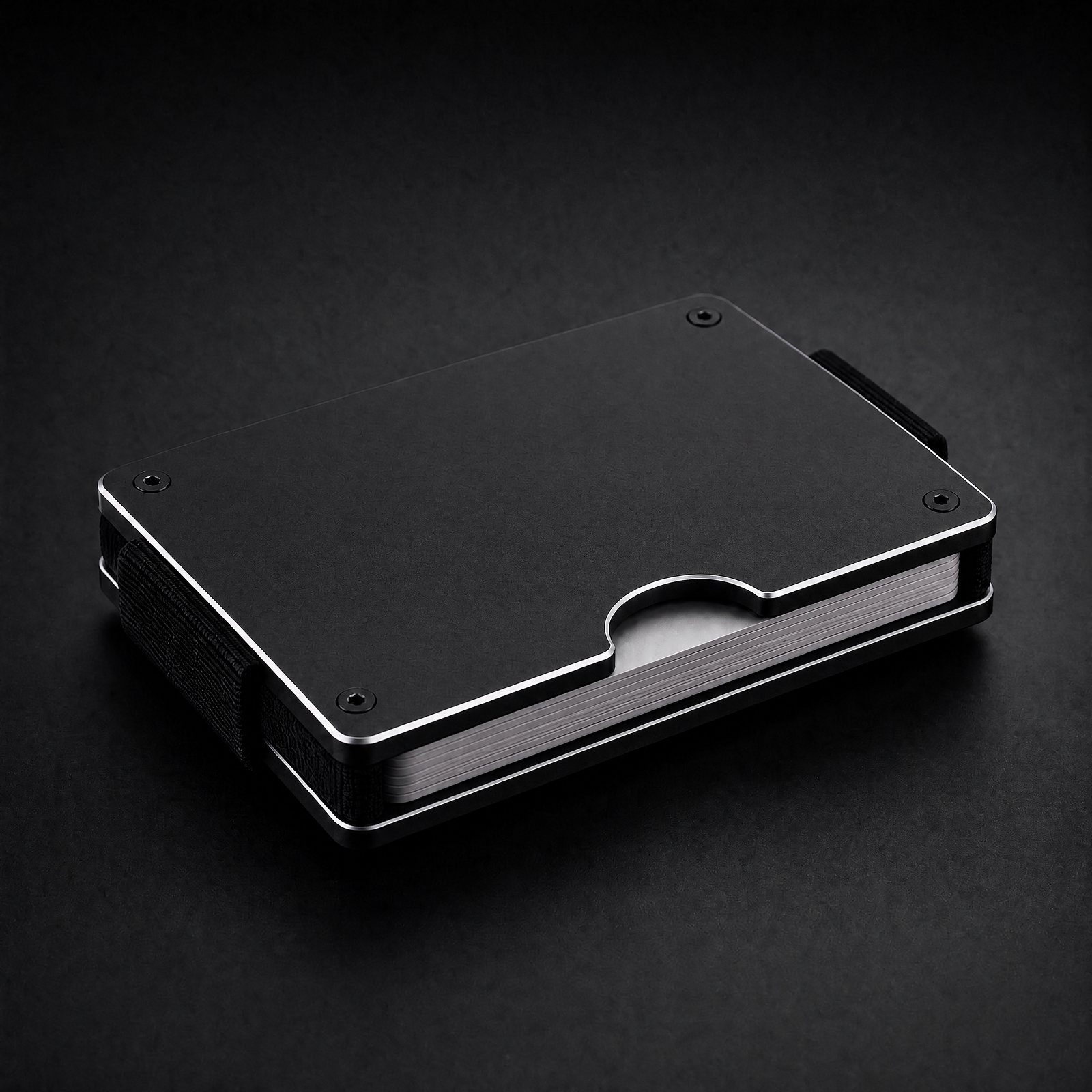 ANODE Aluminum Wallet in matte black, three quarter view with cards between the plates