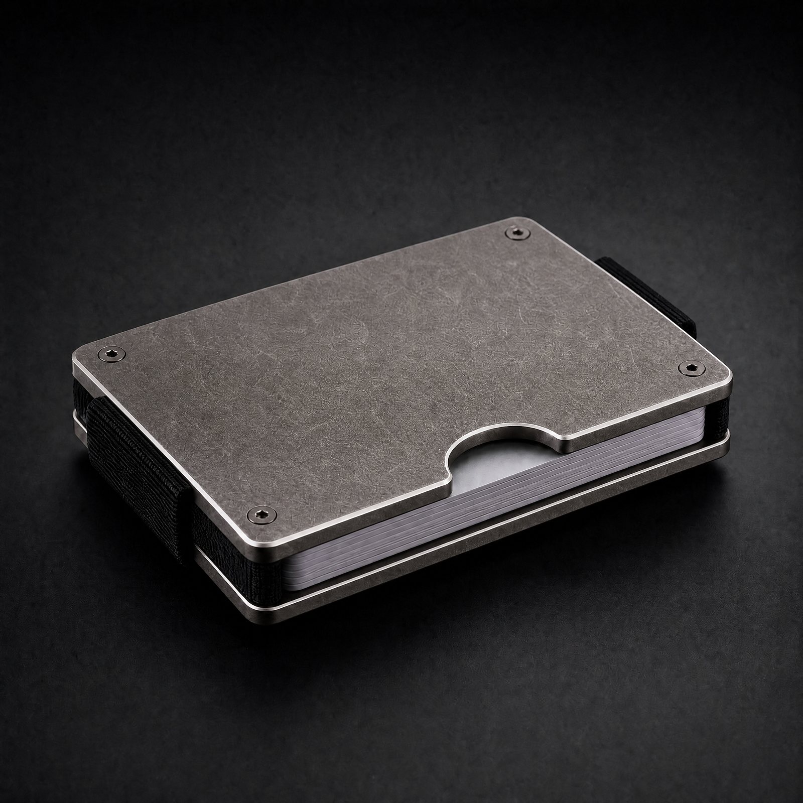ANODE Titanium Wallet in stonewashed titanium, three quarter view with cards between the plates